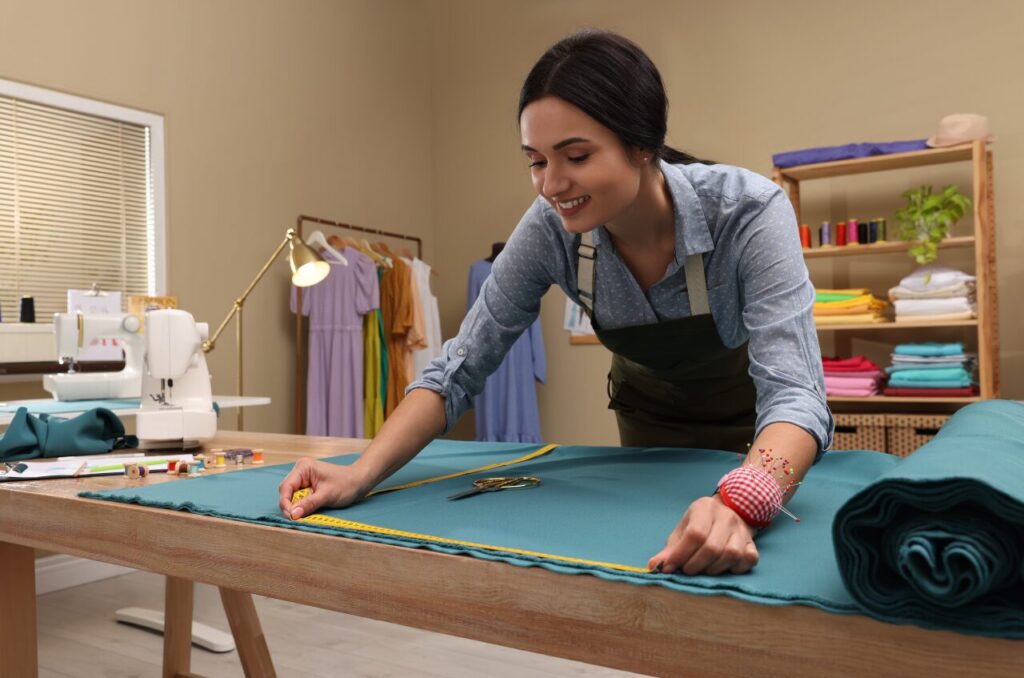 Seamstress tailoring a dress, emphasizing custom fit for plus-size fashion