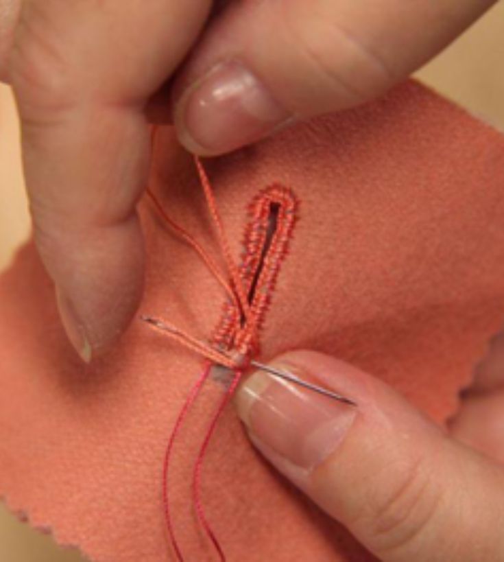 hand stitching buttonhole detail on coral fabric — hand versus machine sewing example