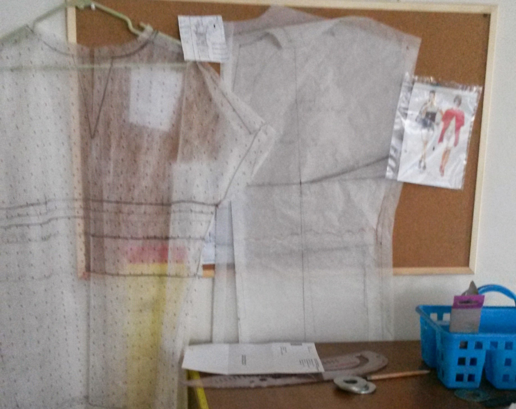 Technical pattern drafting layout for a plus-size garment displayed on a studio board.