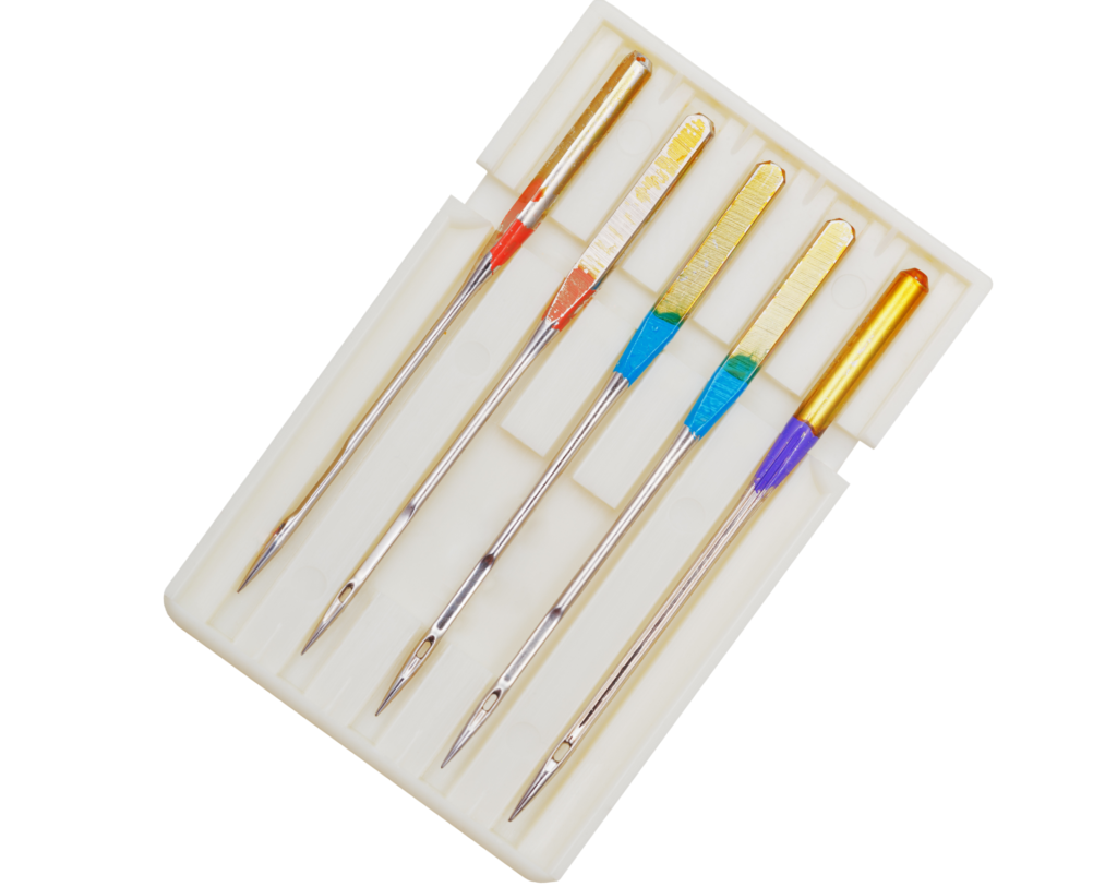 A collection of specialized sewing machine needles, illustrating essential supplies for professional garment fitting.